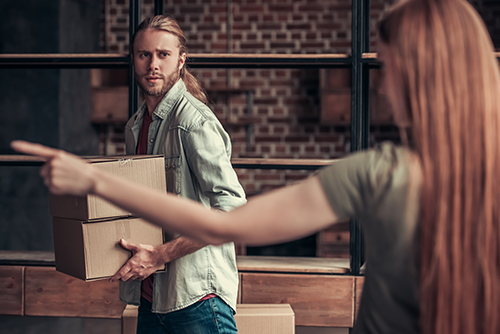 female pointing for male to leave living space