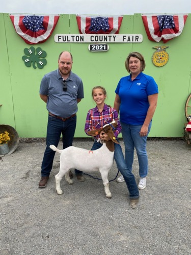 bank reps standing with Laynee and her goat